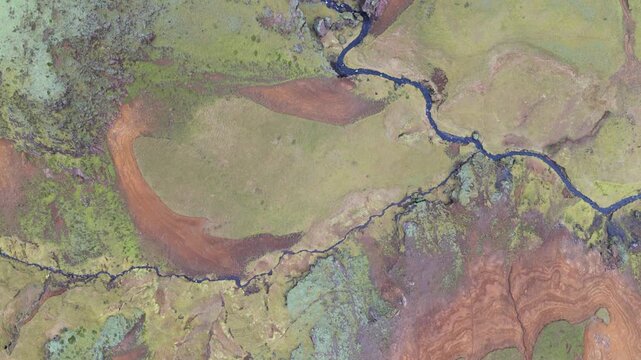 Aerial view of winding river through fields, Iceland.