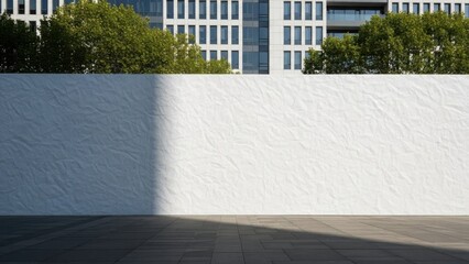 Modern office building facade with sunlight and shadow on a textured wall