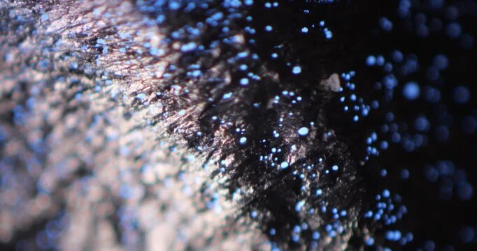 Aluminum (Al) Foil Heated over Open Flame with Micro Pores under Microscope 100x, Blue Light passing through Holes, Micro Filter Creation Technology for Filtering Particles, Material Science Lab