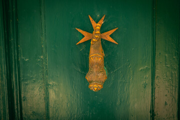 Close-up view of beautiful doors with elegant decorative door handles. Stylish architectural detail, classic design elements, and refined craftsmanship in home or exterior decor.