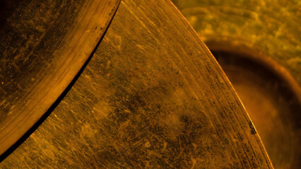 Abstract macro photograph capturing the intricate textures and warm golden hues of weathered wood grain with dramatic lighting effects