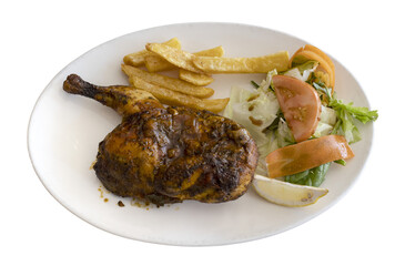 Roasted chicken leg with fries and fresh salad