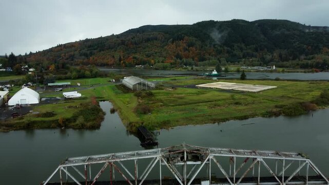 US, WA, Raymond, 2025-10-25 - Drone view of the abandoned train trestle rotating bridge on the Willapa River