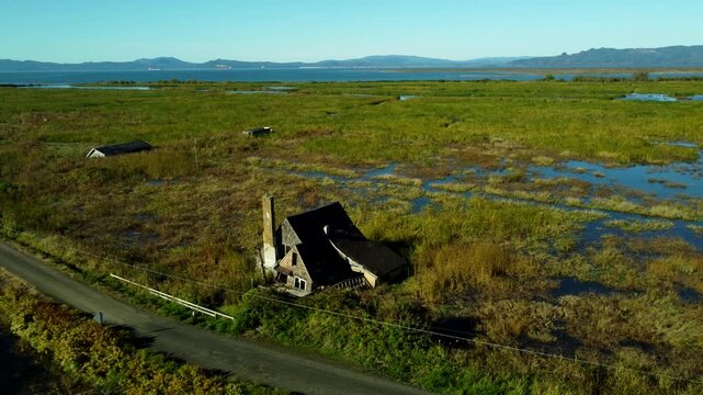 US, OR, Svenson, 2025-10-21 - Drone view of sunken and abandoned housees on an offshoot of the Columbia River near Astoria, Oregon in Fall