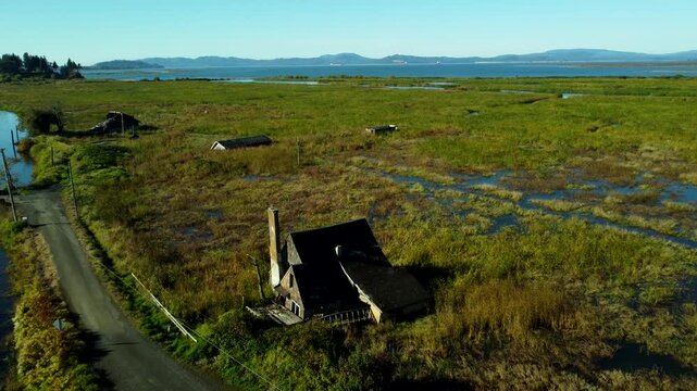 US, OR, Svenson, 2025-10-21 - Drone view of sunken and abandoned housees on an offshoot of the Columbia River near Astoria, Oregon in Fall