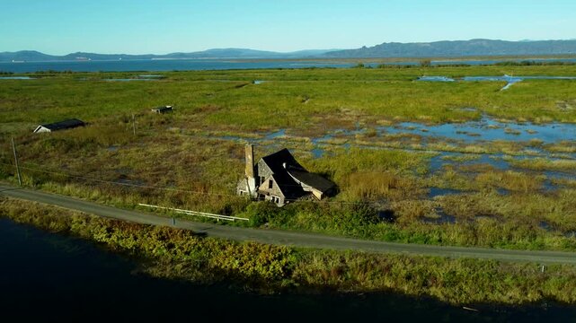 US, OR, Svenson, 2025-10-21 - Drone view of sunken and abandoned housees on an offshoot of the Columbia River near Astoria, Oregon in Fall
