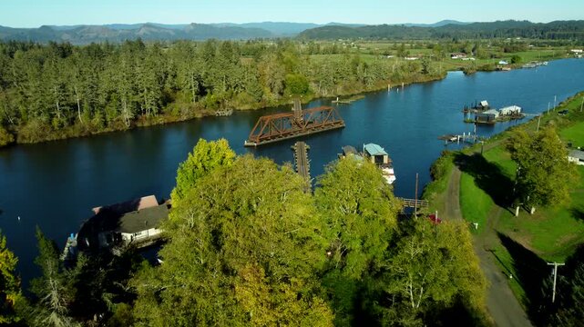 US, OR, Knappa, 2025-10-21 - Drone view of an abandoned railroad trestle on a tributary of the Columbia River.