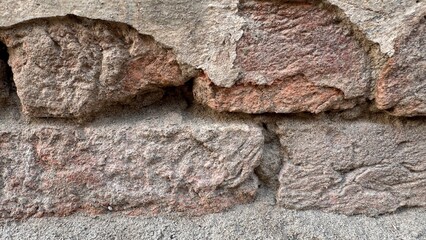 Closeup of textured cement plaster wall featuring long jagged crack creating natural abstract line pattern ideal for construction and grunge backgrounds on white background
