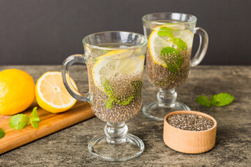 Healthy breakfast or morning with chia seeds lemon and mint on table background, vegetarian food, diet and health concept. Chia pudding with lemon and mint