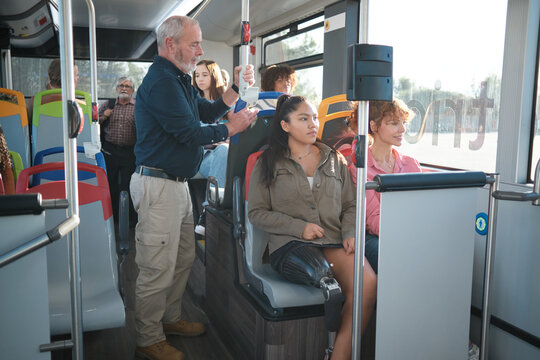 Woman with prosthetic leg commuting on public bus