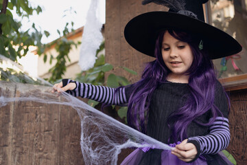 Little girl decorates house for Halloween party