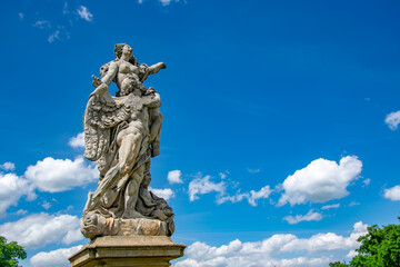 Baroque garden sculpture of loving couple in Ksiaz (Furstenberg) Castle, Lower Silesia, Poland against picturesque sky