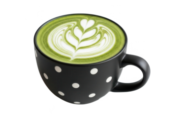 A delicious matcha latte with intricate latte art in a black polka dot mug.