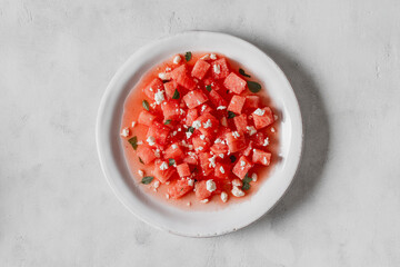 Salad made with watermelon, feta, and mint leaves.