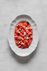  Salad made with watermelon, feta, and mint leaves.