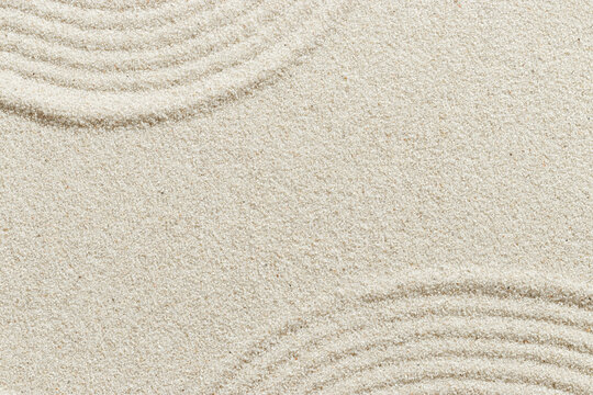 Smooth simple Lines on sand background, minimal aesthetic sandy texture. Spa, meditation, relaxation, wellness concept. Natural beige waves pattern in Japanese zen garden. View from above copy space