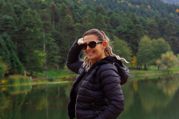 portrait of young beautiful woman near the lake in Autumn	