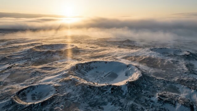Dramatic aerial view of snow-covered volcanic craters under a vibrant sunrise with golden light and mist - Powered by Adobe