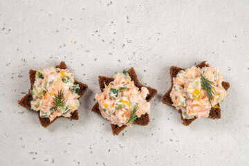 Sourdough bread topped with salmon pate served on a light background