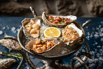 Assorted oyster tartare with lemon on ice