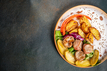Roasted potatoes with meat rolls and vegetables