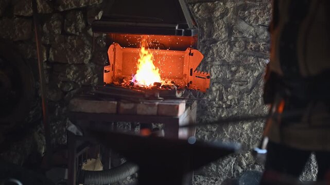 A Viking blacksmith with a white beard and braided hair works intently at a forge, hammering glowing metal on an anvil, with flames flickering in the background of a stone workshop cinematic slow