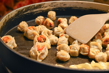 Fried dumplings with shrimps as asian street food at market