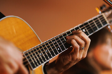 Musician playing acoustic guitar closeup on strings