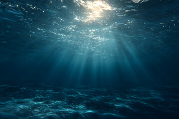Fototapeta premium Sunlight shining through the ocean water creating beams of light underwater and a wavy ocean floor view