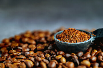 Ground coffee in Coffee scoop  or coffee ground and coffee beans, Close-up