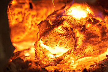 Close-up of smoldering wood after burning. Firewood burning in a rural stove.