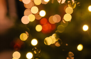 Defocused multi-color bokeh lights with dominant warm tones and red highlights, creating layered abstract circles on dark background