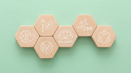 Arrangement of wooden hexagons showcases iconic health elements such as nutritious food, brain health, physical activity, community connection, and balanced wellness.