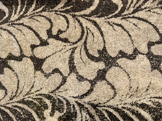Close up of carpet texture in random black and beige leaves foliage pattern. For rug, carpet, fabric, and upholstery finishes. Seamless background texture.