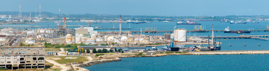 Aerial view of the petrochemical complex located on the coast overlooking the sea. Large oil refinery. © Stefano Tammaro