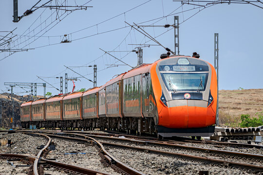 India's first indigenous development semi high speed orange Vande Bharat express , also known as train 18 , on a curve.
