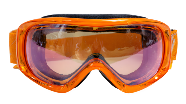 Close up of orange ski goggles with tinted lenses and black strap on a black background studio shot