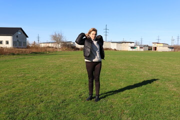 Woman doing morning exercises on an outdoor sports ground