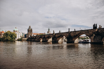 Scenic view of the historic Charles Bridge over the Vltava River in Prague.
