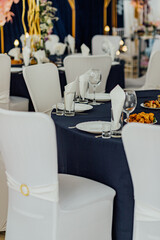 Elegant table setting with white decor and gourmet dishes at a formal event.