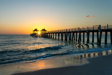 Fototapeta premium Naples pier at sunset, damaged by Hurricane Ian, Florida scenic landscape