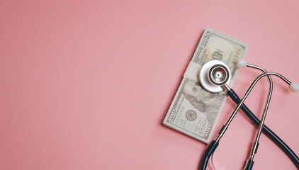 Medical cost concept with stethoscope and money on pink background, symbolizing healthcare expense and financial health management with calm tone