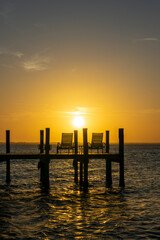 Boat pier and palm trees, sunset landscape on the Banana River in Cocoa Beach, Florida