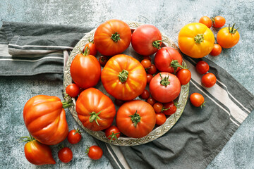 Red tomatoes background, top view. Fresh ripe tomatoes. Harvest tomatoes. Heirloom tomato background