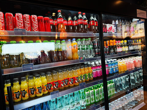 Fridge stocked with sodas and juices shop