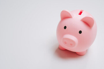 Pink piggy bank saving money concept isolated on white background cute coin container financial planning minimalistic design soft lighting close up view