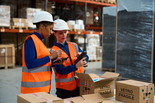 Women warehouse workers scanning inventory for logistics operations