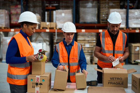 Warehouse workers packing boxes for logistics and distribution