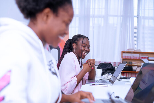 Two african girls interacting during the work time