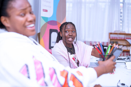 Two african girls interacting during the work time